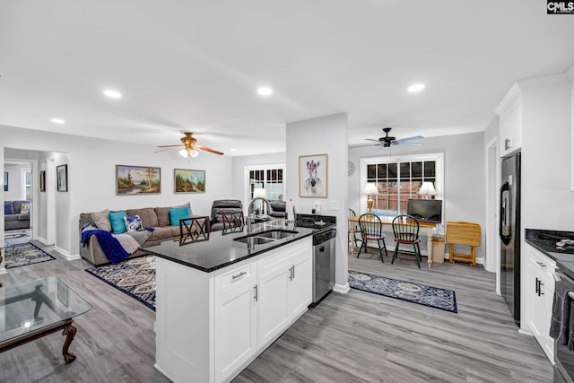 kitchen with black refrigerator, white cabinetry, dishwasher, sink, and kitchen peninsula