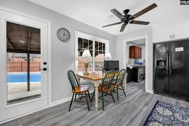 dining room featuring light hardwood / wood-style flooring and ceiling fan