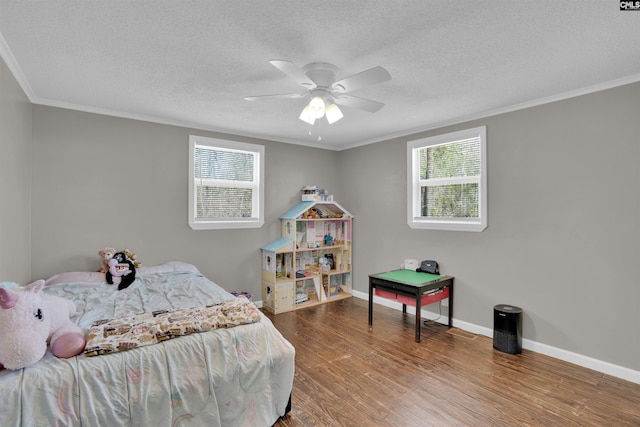 bedroom featuring multiple windows, hardwood / wood-style flooring, and ornamental molding