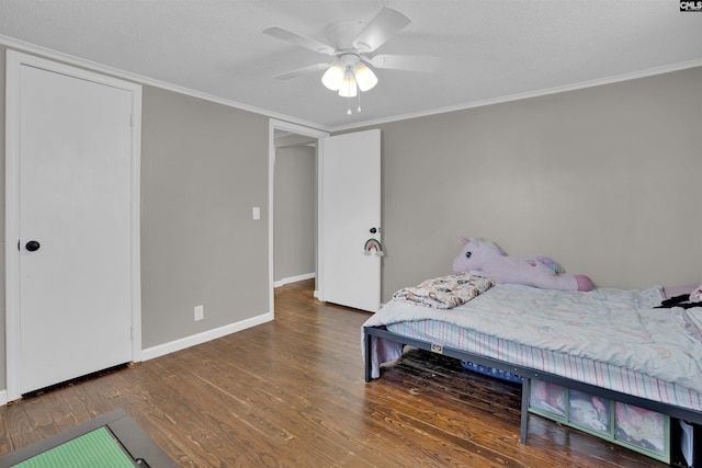 bedroom featuring crown molding, ceiling fan, a textured ceiling, and hardwood / wood-style flooring