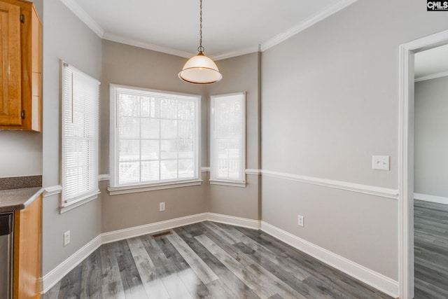 unfurnished dining area with crown molding and hardwood / wood-style floors