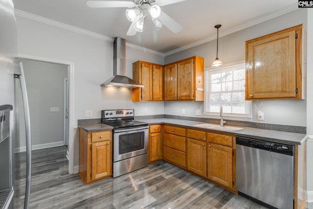 kitchen with sink, crown molding, appliances with stainless steel finishes, hardwood / wood-style floors, and wall chimney range hood