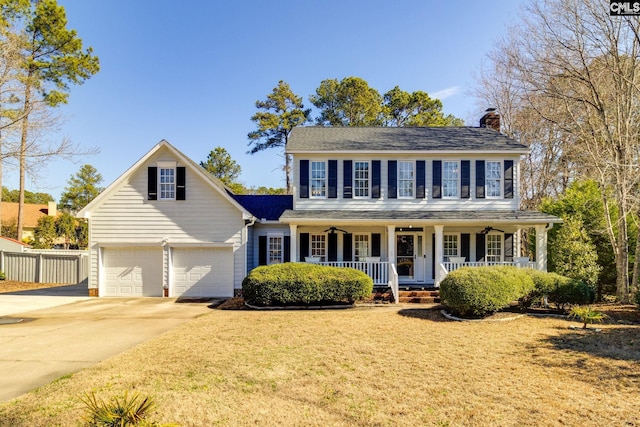 colonial home with a garage and covered porch