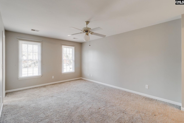 empty room with light colored carpet and ceiling fan