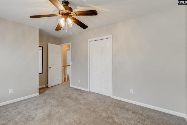 unfurnished bedroom with light carpet, ceiling fan, and a closet