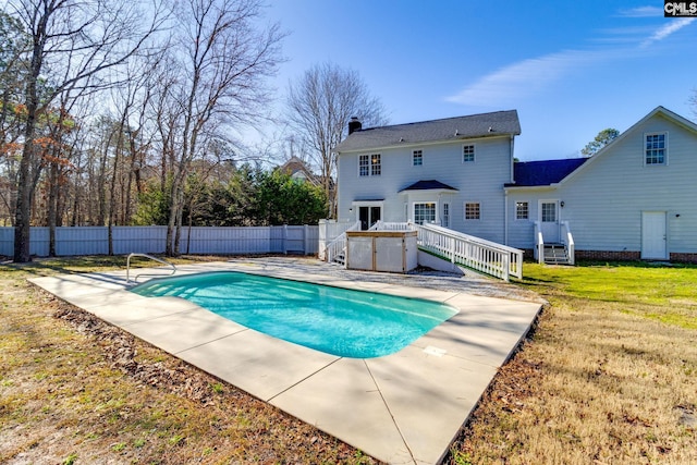 view of swimming pool featuring a yard and a patio