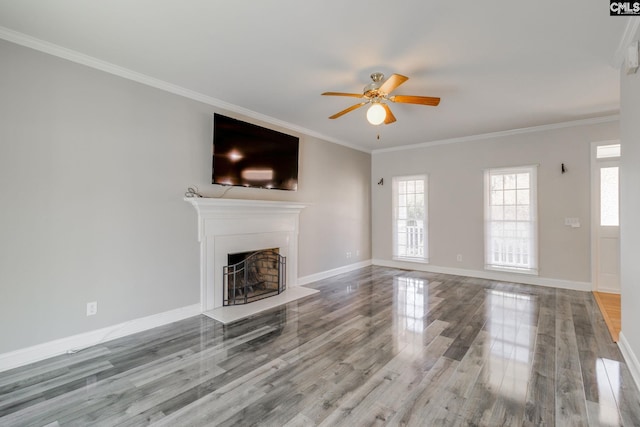 unfurnished living room featuring hardwood / wood-style flooring, ceiling fan, and ornamental molding