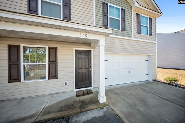 view of exterior entry featuring a garage