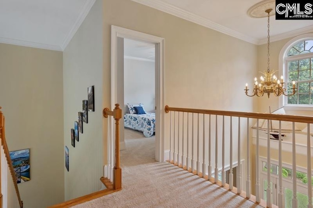 corridor with ornamental molding, light carpet, and a notable chandelier