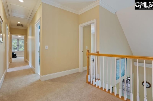 hallway with ornamental molding and light colored carpet