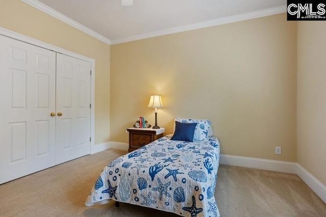 carpeted bedroom featuring ornamental molding and a closet