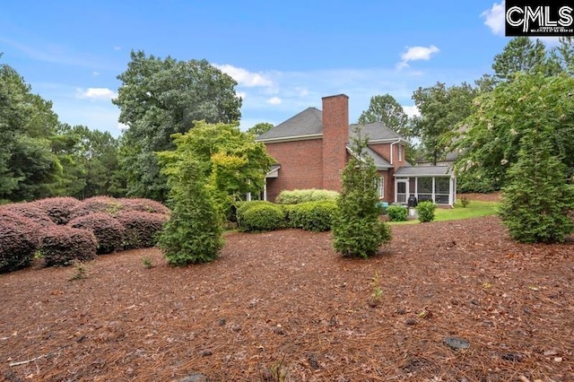 view of home's exterior featuring a sunroom