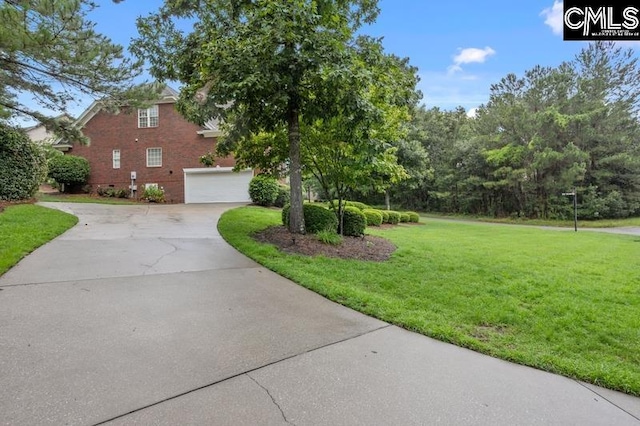 view of front of property featuring a garage and a front lawn