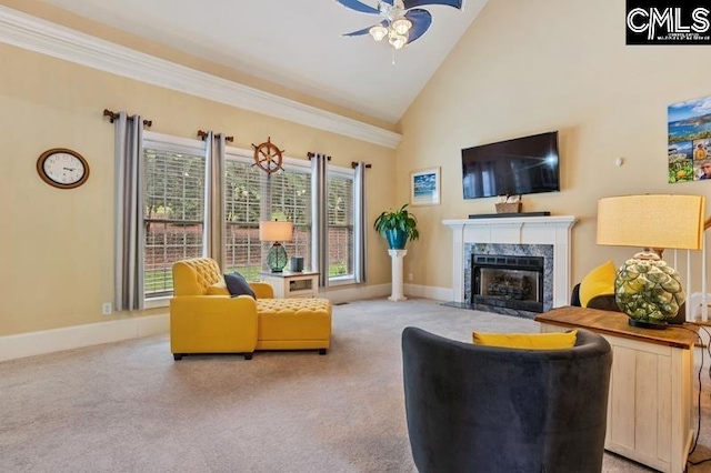 carpeted living room with ornamental molding, high vaulted ceiling, ceiling fan, and a high end fireplace