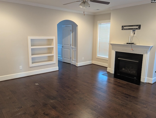 unfurnished living room with crown molding, ceiling fan, dark hardwood / wood-style flooring, and built in features