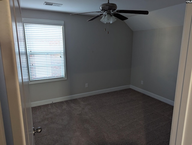 carpeted empty room with ceiling fan and lofted ceiling