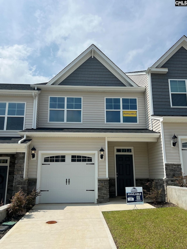 view of front of property featuring a garage and a front lawn