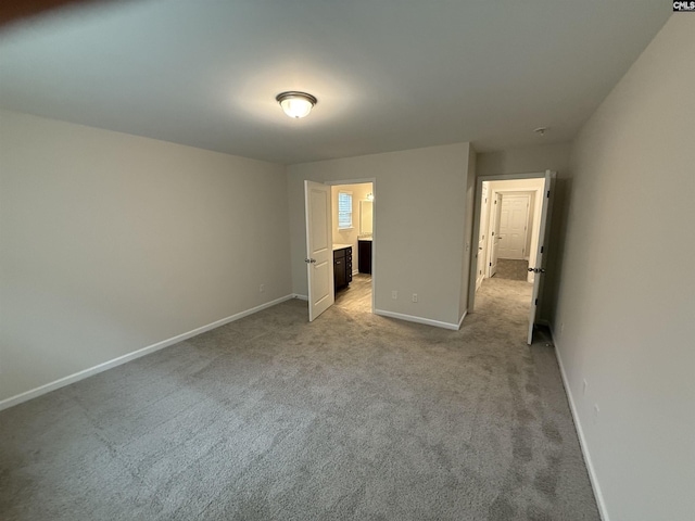 unfurnished bedroom featuring light colored carpet