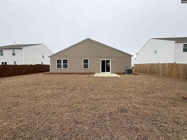 rear view of house featuring a patio and central AC