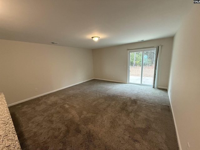 empty room with dark colored carpet