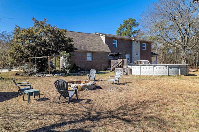 rear view of house featuring an outdoor fire pit