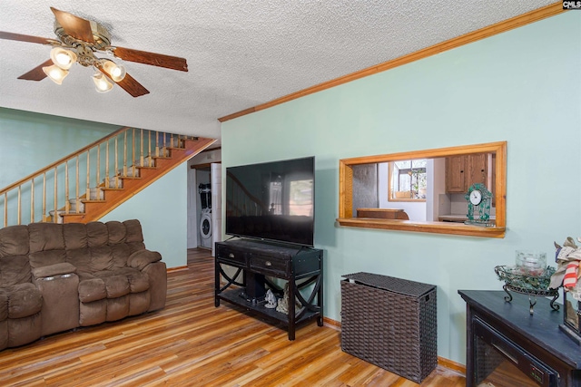 living room with crown molding, ceiling fan, a textured ceiling, and light hardwood / wood-style flooring