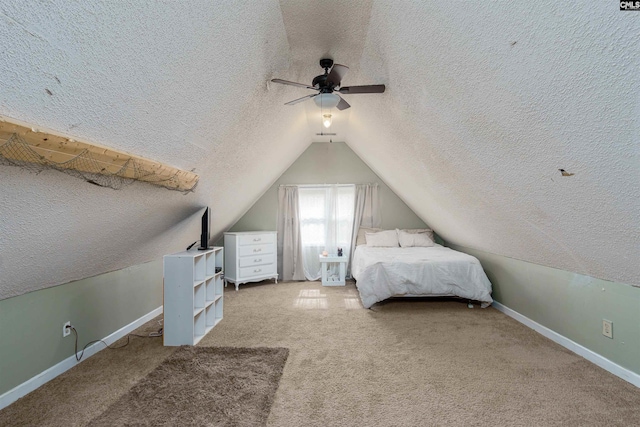 unfurnished bedroom featuring carpet, a textured ceiling, lofted ceiling, and ceiling fan