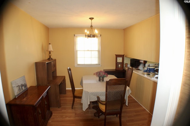 dining room featuring hardwood / wood-style floors and an inviting chandelier