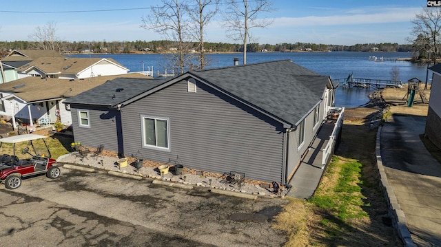 view of side of home featuring a water view