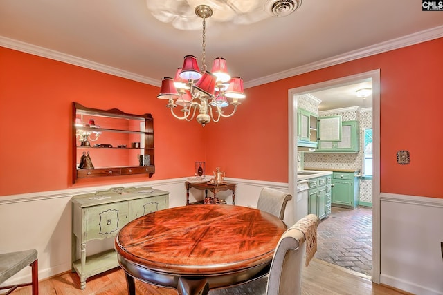 dining space featuring an inviting chandelier and crown molding