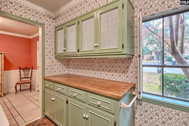 kitchen featuring crown molding, butcher block counters, and green cabinetry