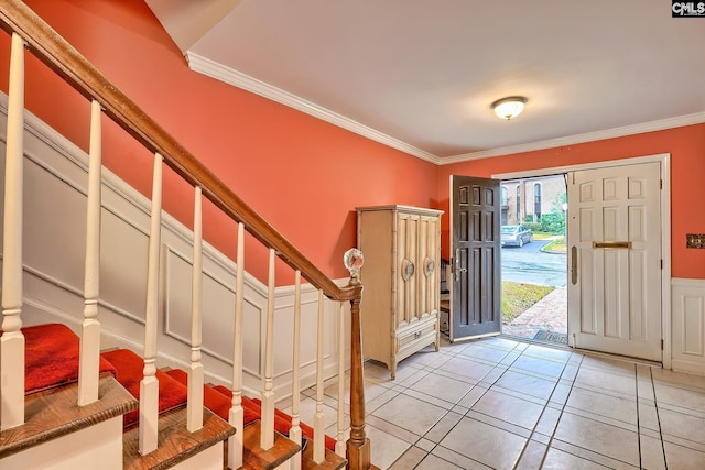 entrance foyer with ornamental molding and light tile patterned floors