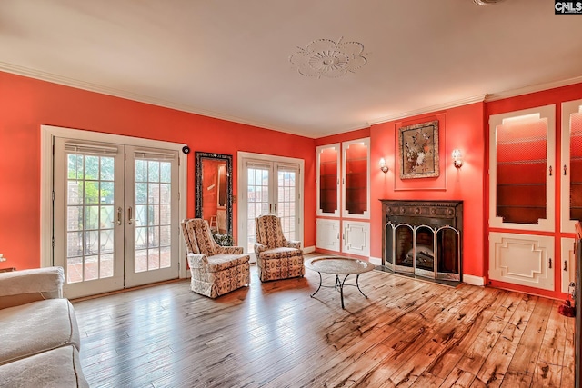 unfurnished room featuring crown molding, light hardwood / wood-style flooring, and french doors