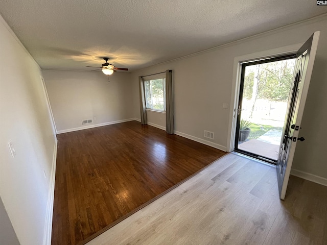 interior space with hardwood / wood-style flooring, ceiling fan, and a textured ceiling