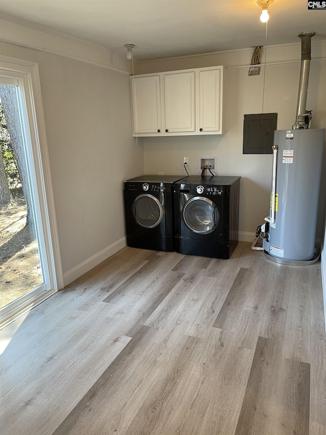 laundry area with washing machine and clothes dryer, cabinets, light wood-type flooring, electric panel, and water heater