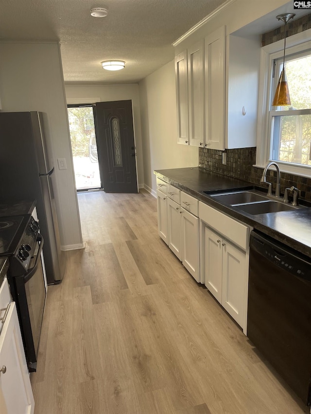 kitchen featuring white cabinets, decorative light fixtures, sink, and black appliances