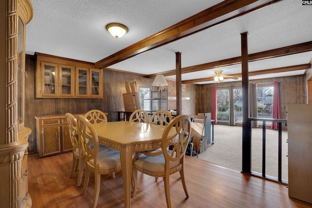 dining room with plenty of natural light and wood walls