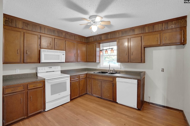 kitchen with sink, light wood-type flooring, white appliances, ceiling fan, and a textured ceiling