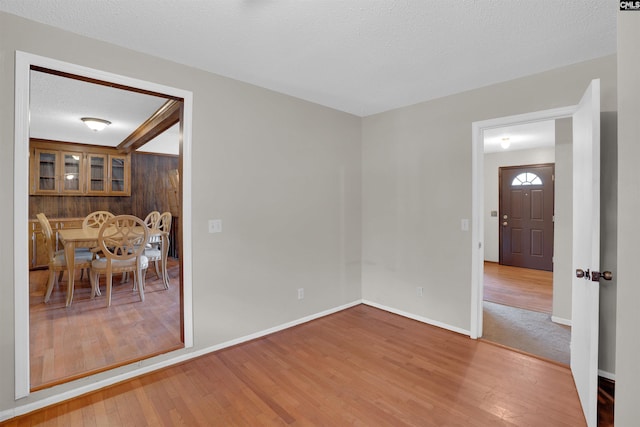 unfurnished room featuring hardwood / wood-style floors and a textured ceiling