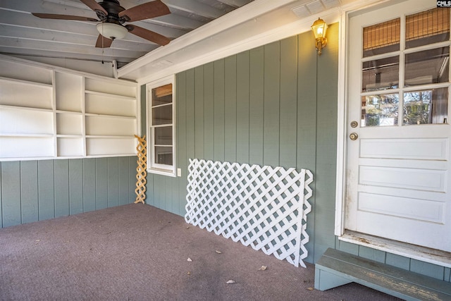 view of exterior entry with ceiling fan