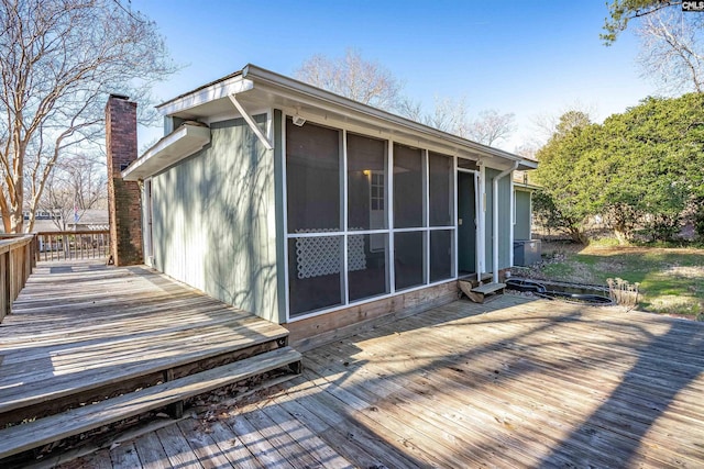 wooden deck featuring a sunroom