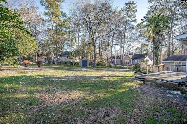 view of yard featuring a storage shed and a deck