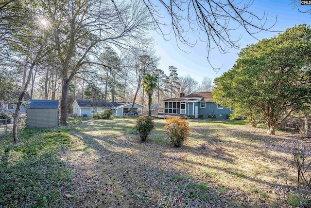 view of yard with a shed and a sunroom