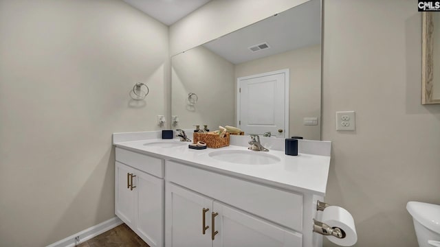 bathroom with vanity and toilet