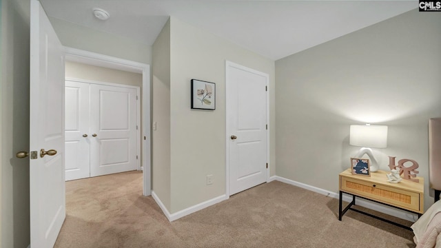 hallway with light colored carpet