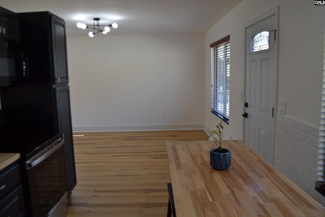 dining area with a chandelier and light hardwood / wood-style floors