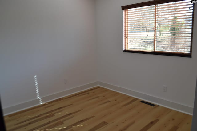 spare room with wood-type flooring