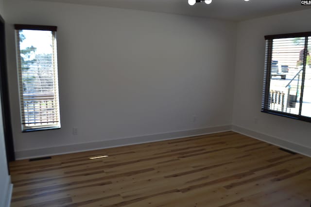 unfurnished room with dark hardwood / wood-style floors