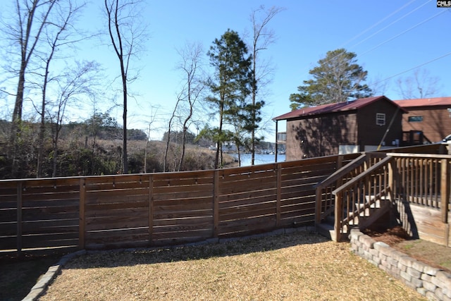 view of yard featuring a deck with water view