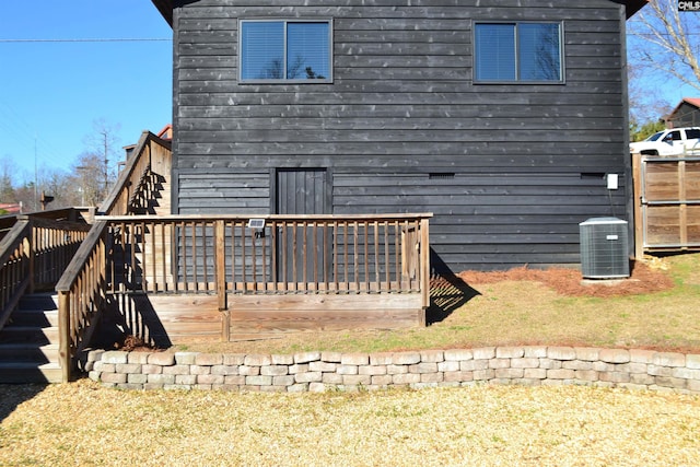 back of property featuring a deck and central AC